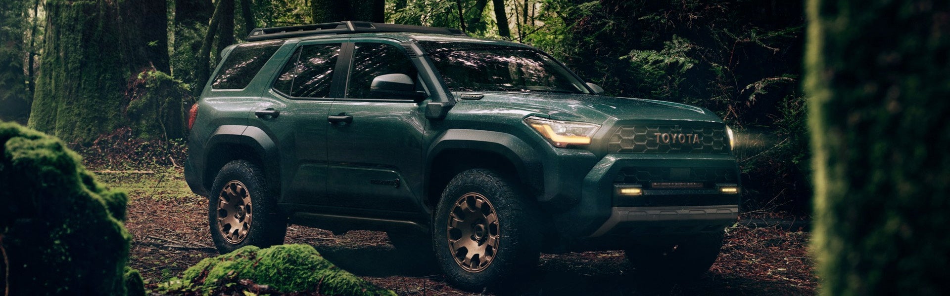 A green suv sitting parked outdoors.