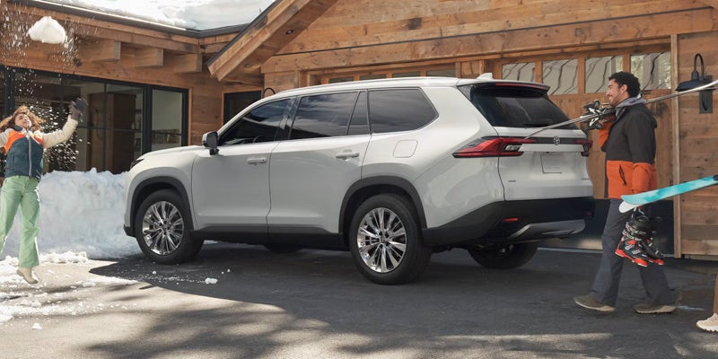 A silver suv parked ina driveway.