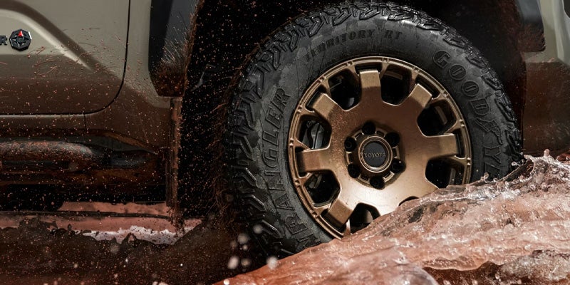 Upclose view the tires on the toyota tacoma i-force max hybrid.