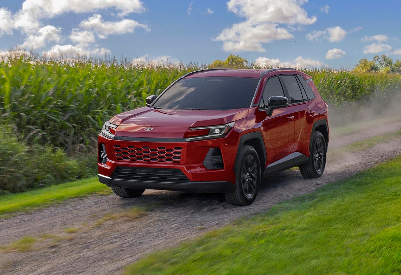 Red Toyota RAV4 driving on dirt road