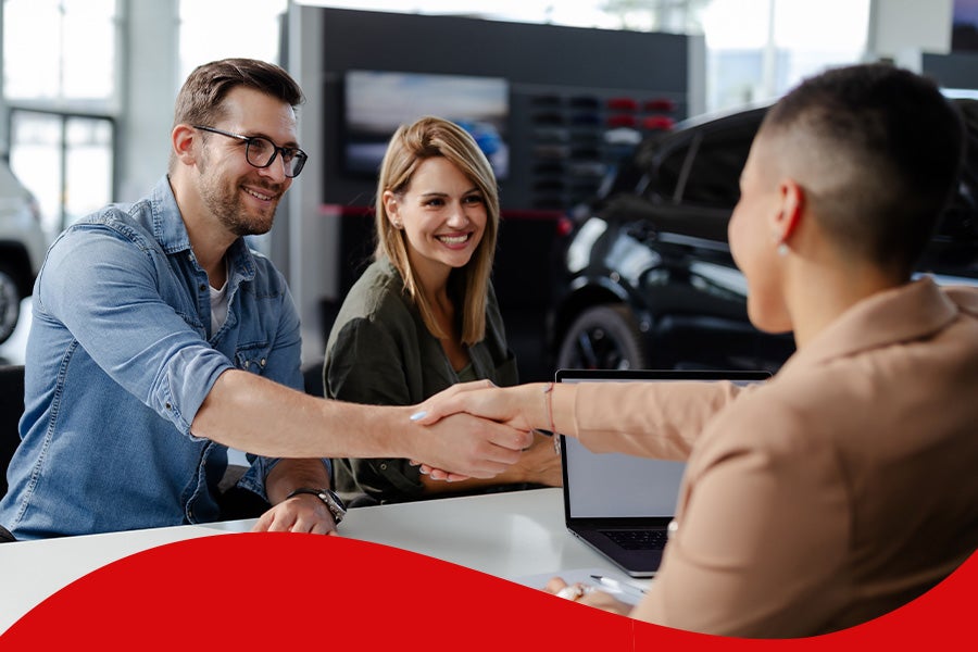 Couple Shaking Hands with Sales Man