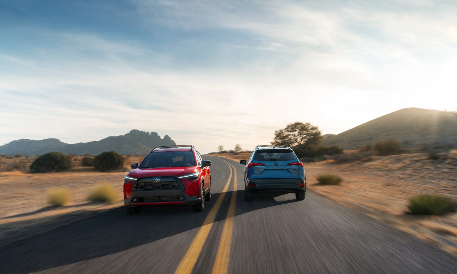 two 2026 toyota corolla cross parked with a desert view in the back ground