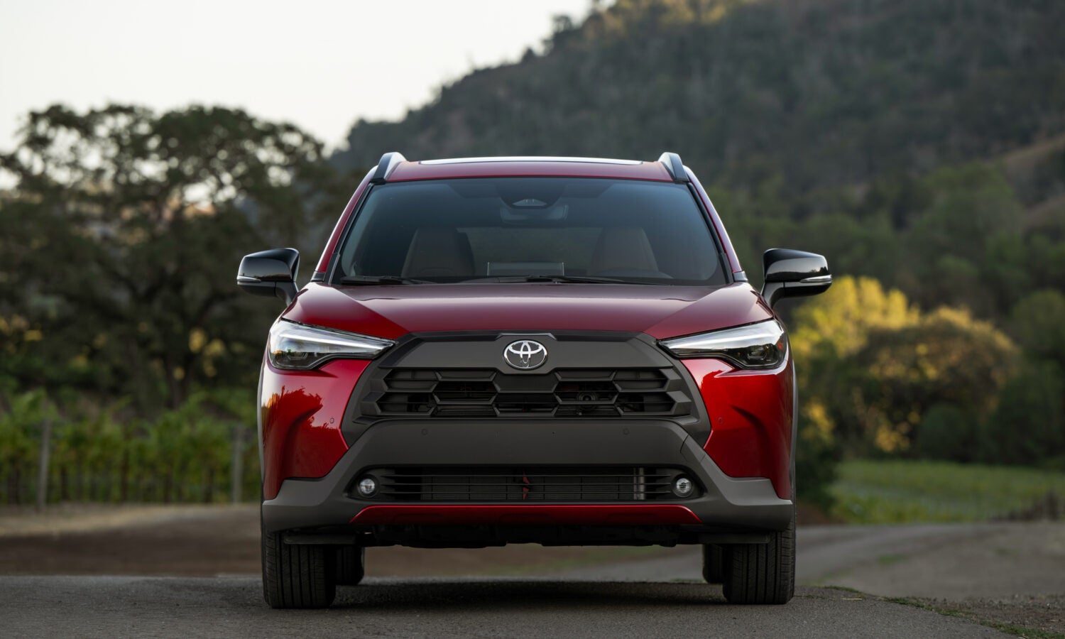 the front end of a red 2026 toyota corolla cross