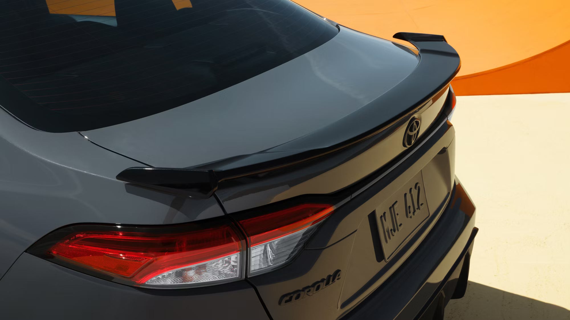 the rear of a black toyota corolla showcasing the toyota emblem