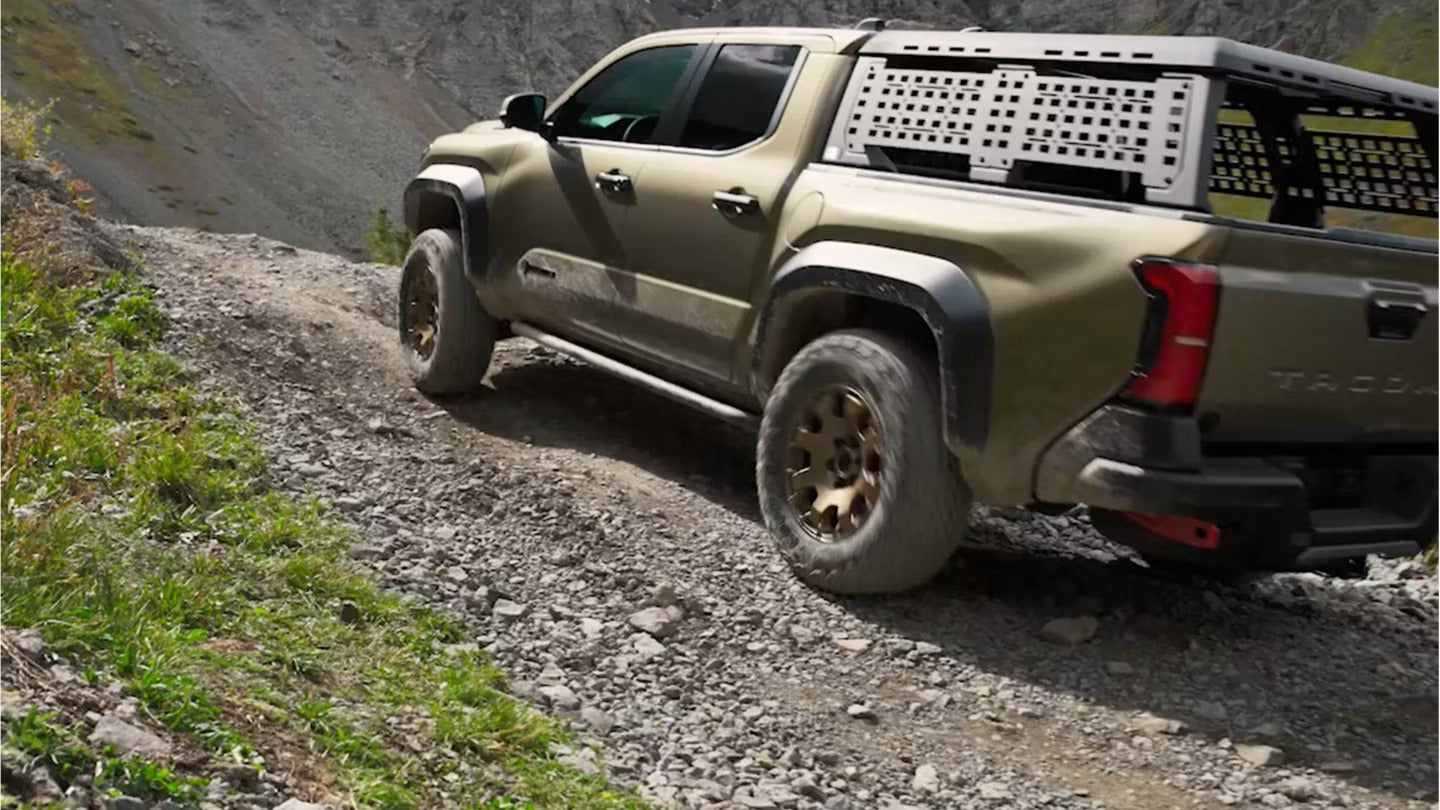 A green truck driving off-road.