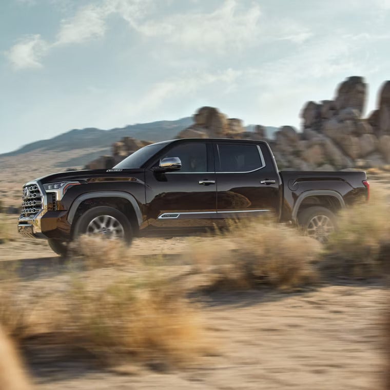 A brown truck driving off road.