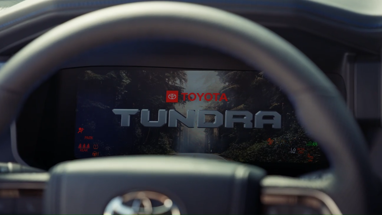 Toyota Tundra digital display showing the Tundra logo behind the steering wheel