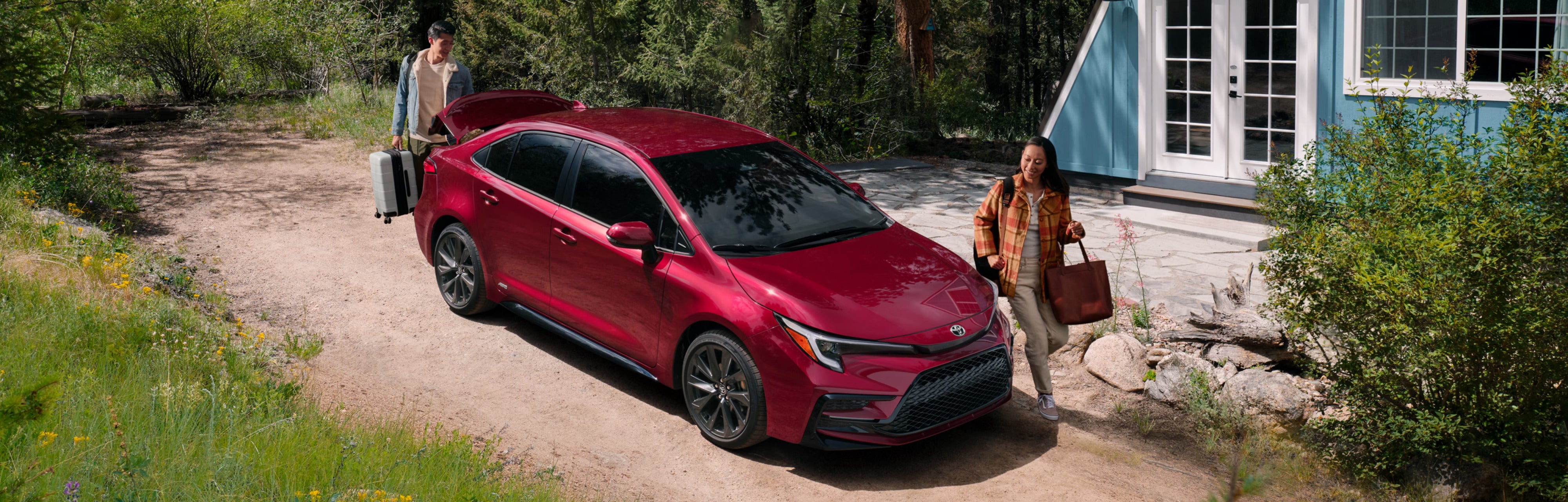 A red car parked in a driveway.