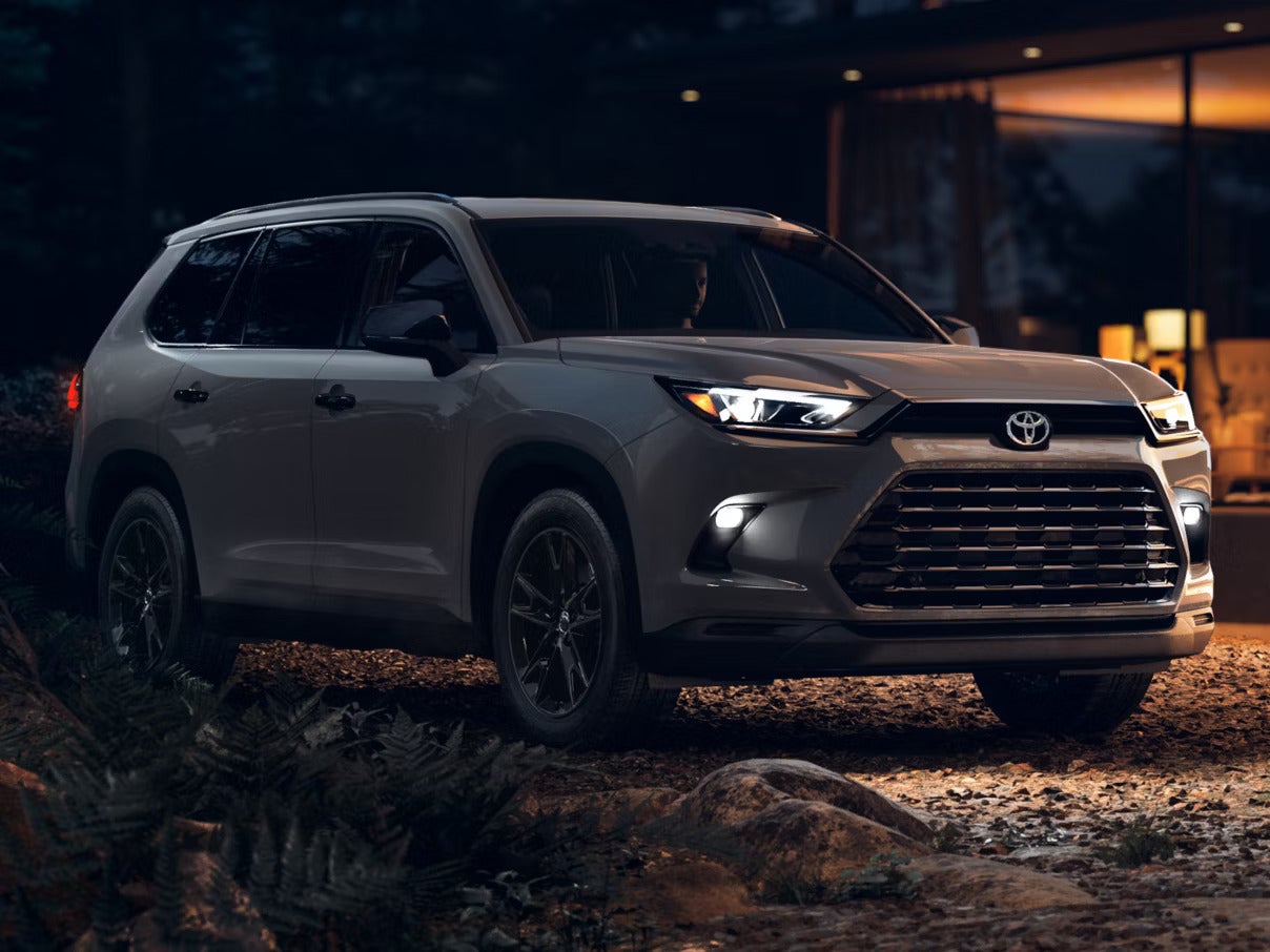 A suv pulling a jet ski down the road.