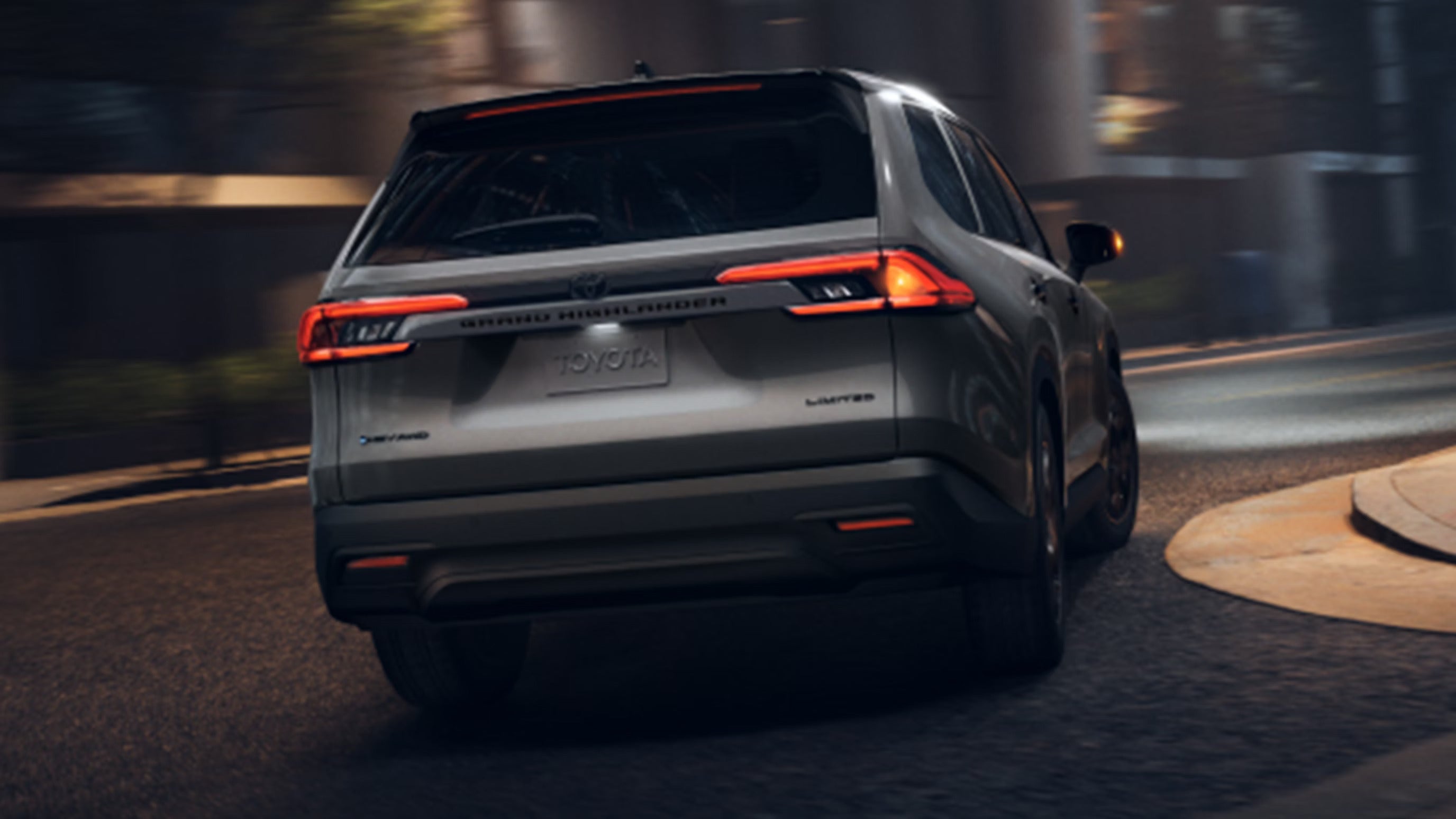 A gray suv driving on the road.