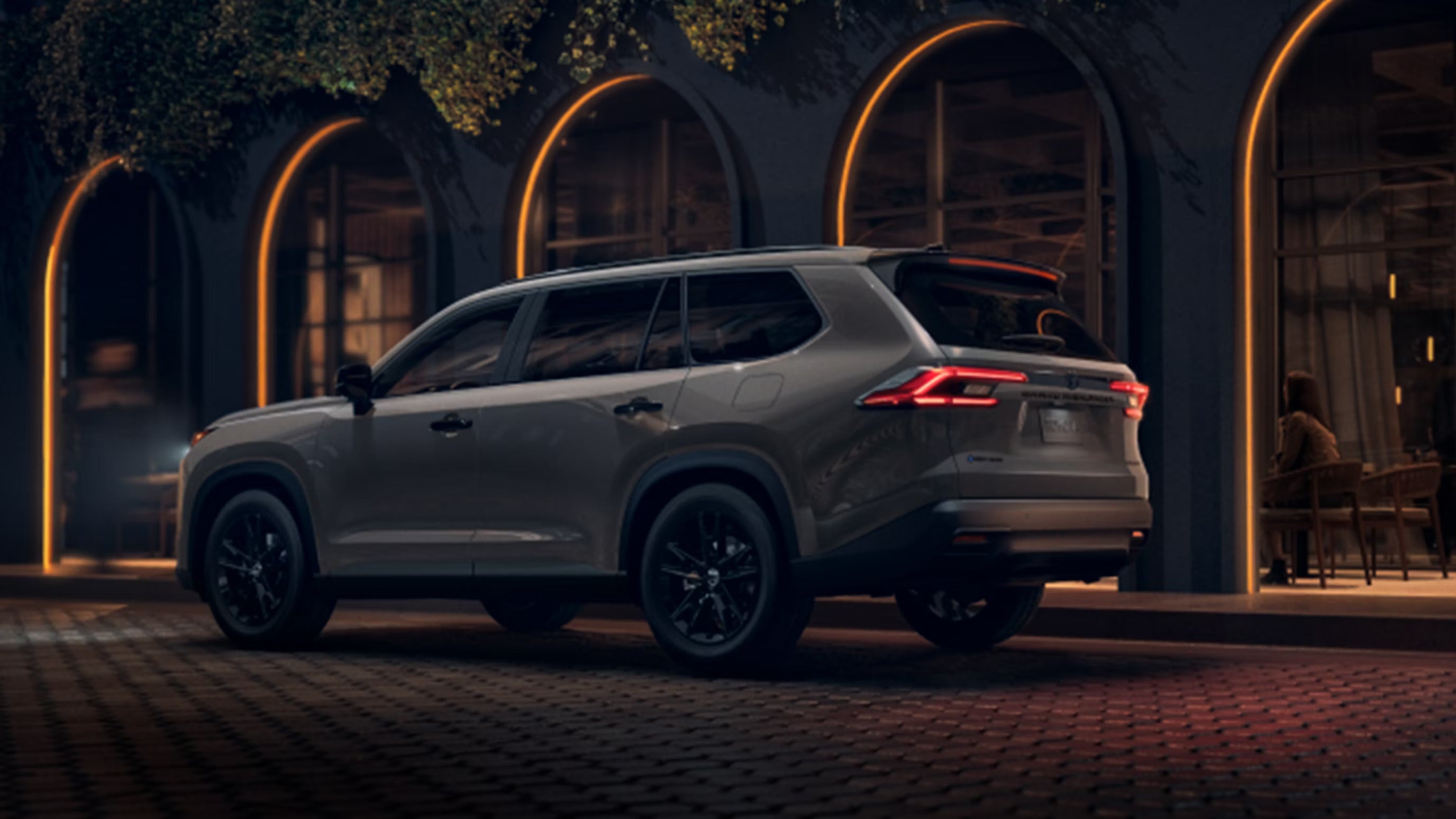 A gray suv sitting in the road.