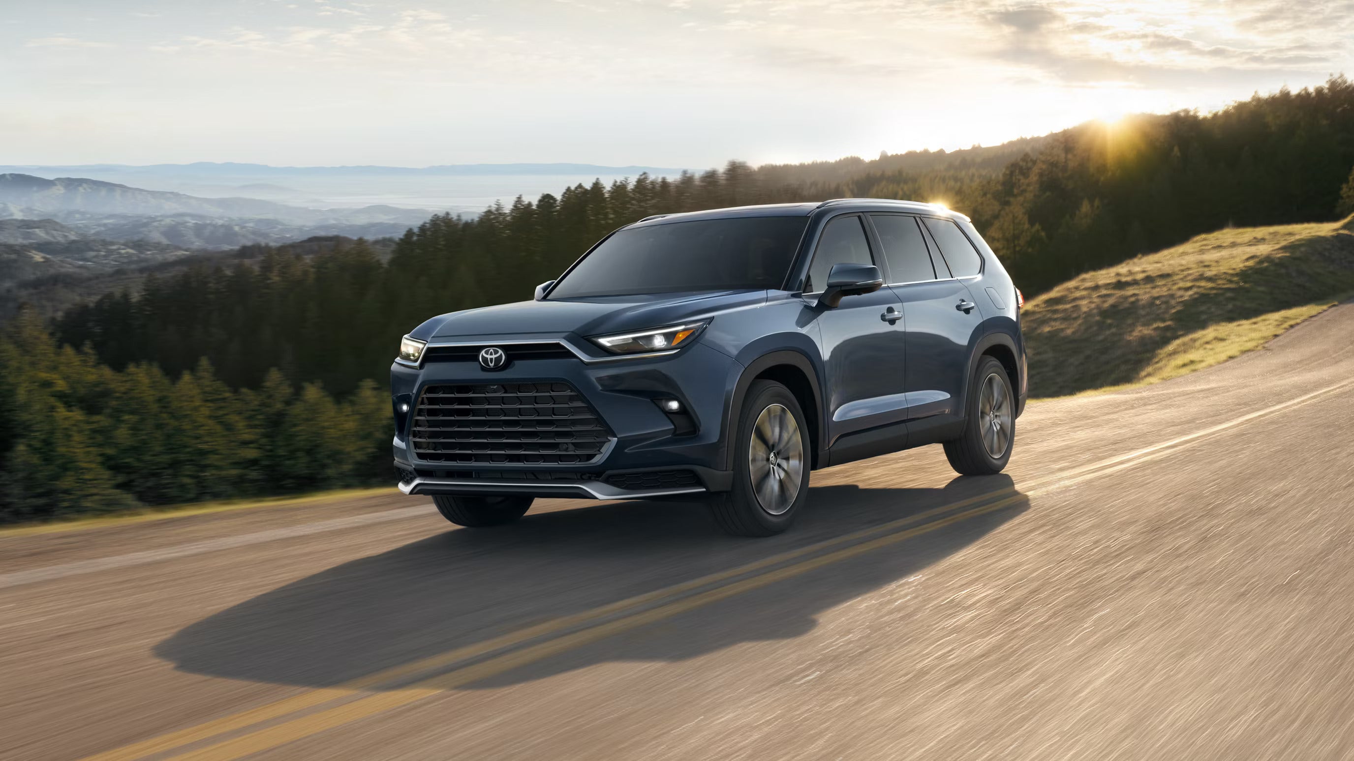 A blue suv driving on the road.