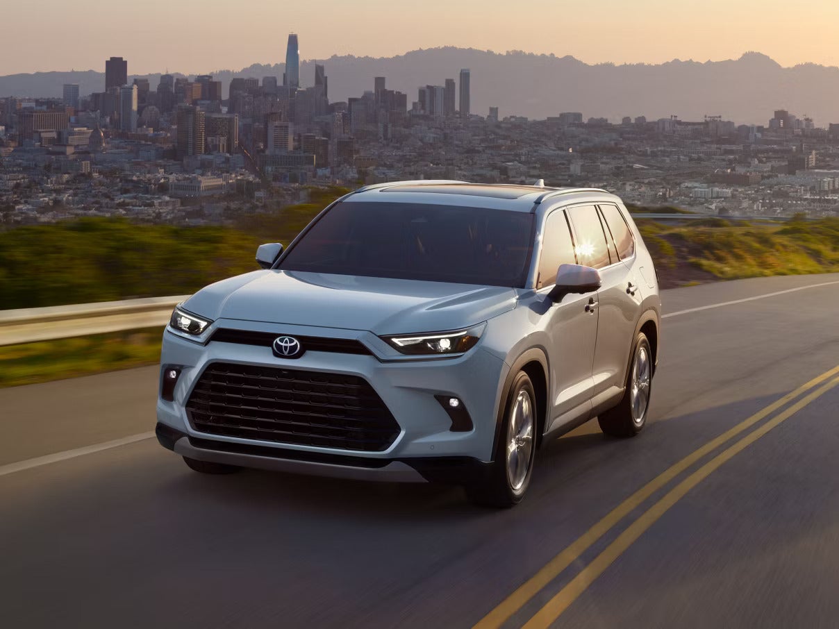 A gray suv driving on the road.