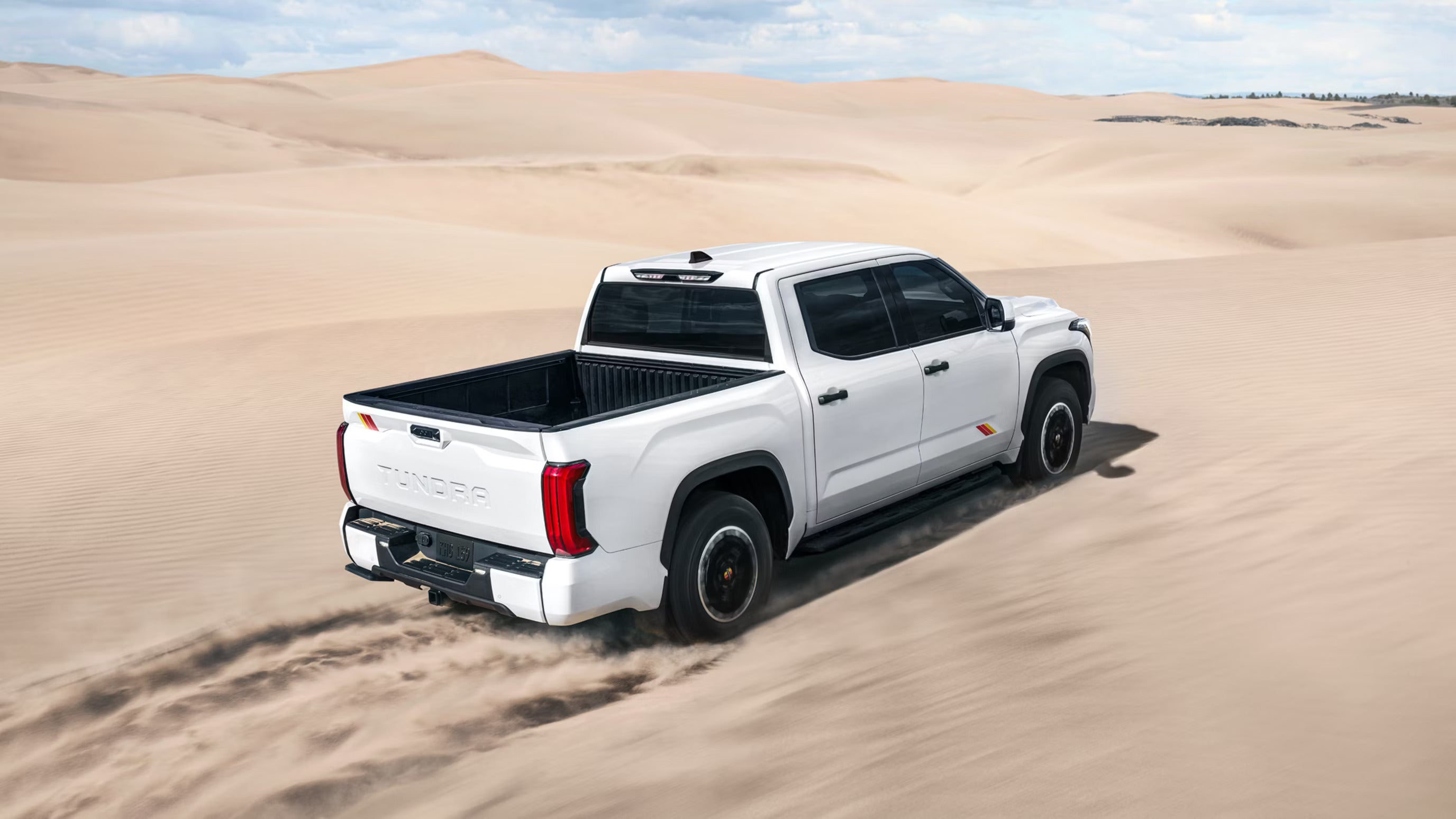 A white truck driving off-road.