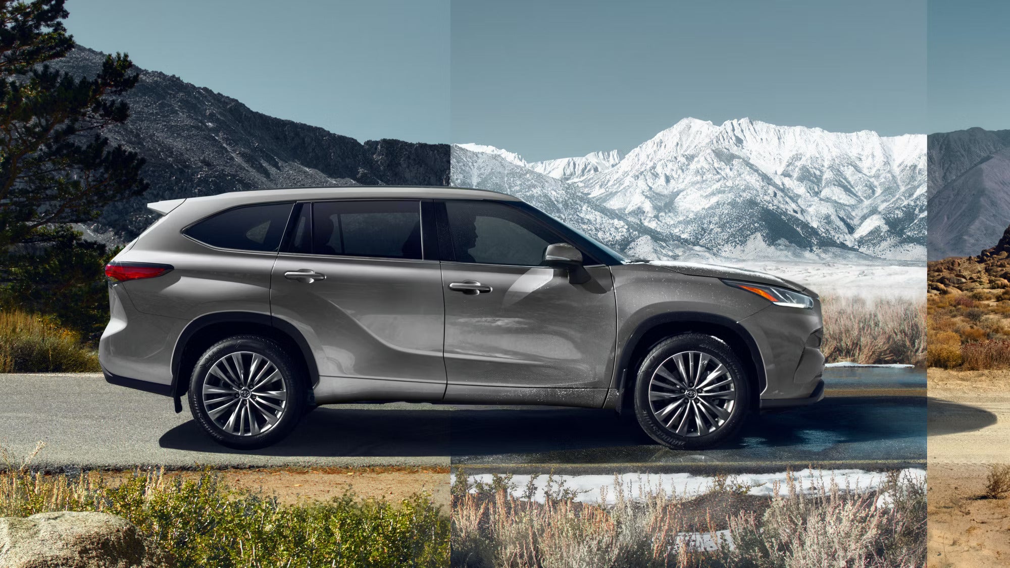 A silver suv sitting in the road.