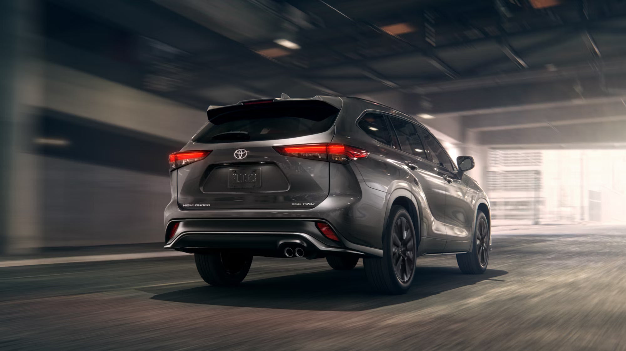 A silver suv driving on a road.