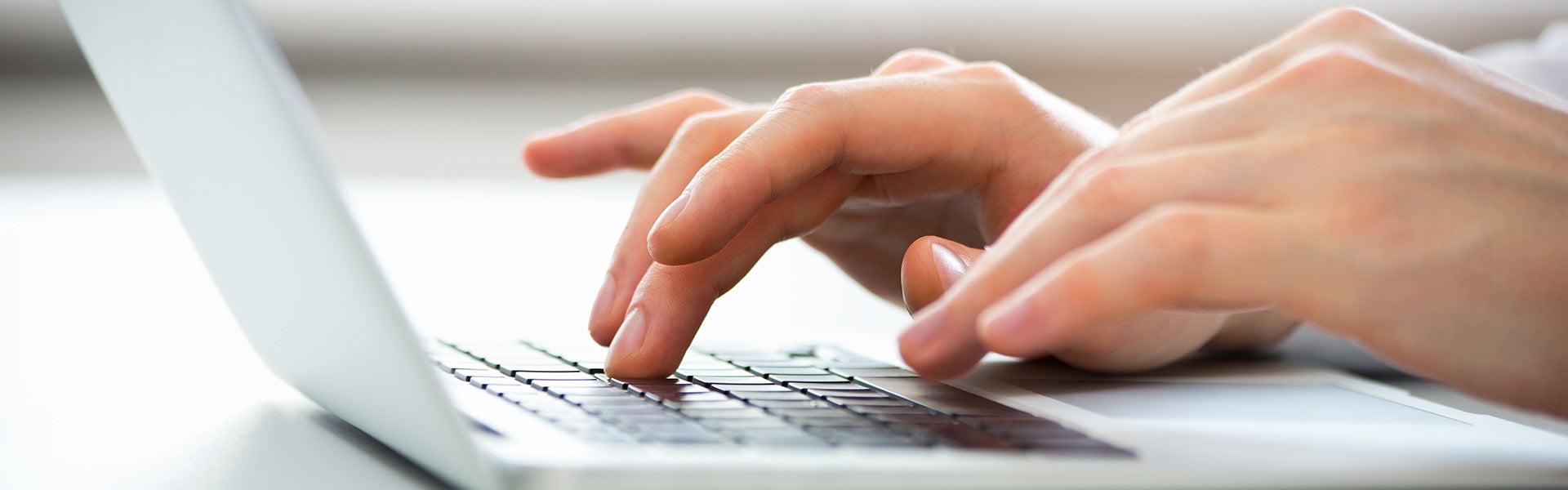 hand typing on laptop