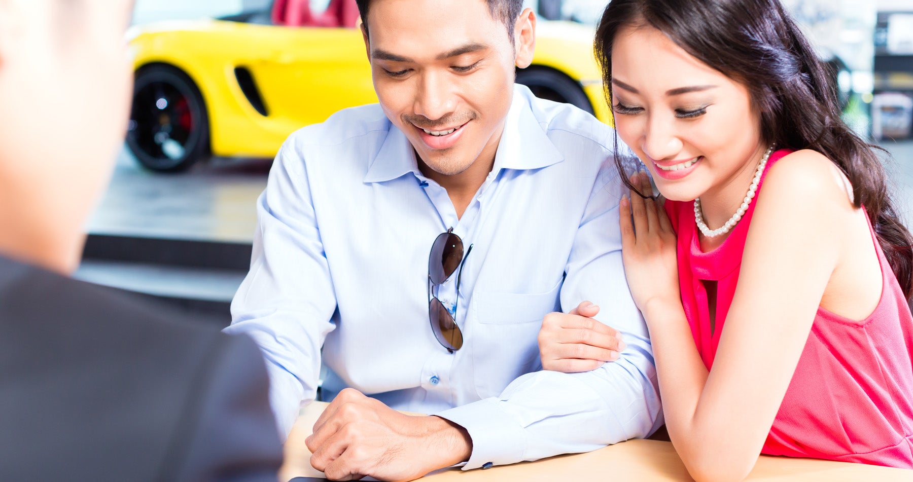 a couple talking with finance staff looking at information on a table